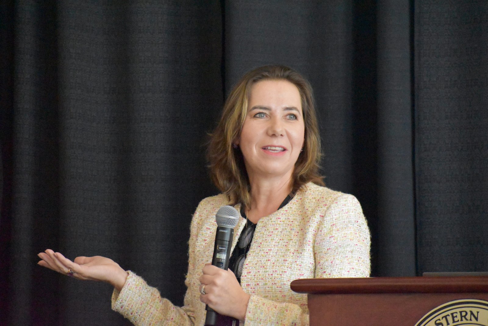 Dr. Julia Ivy smiling while giving a keynote